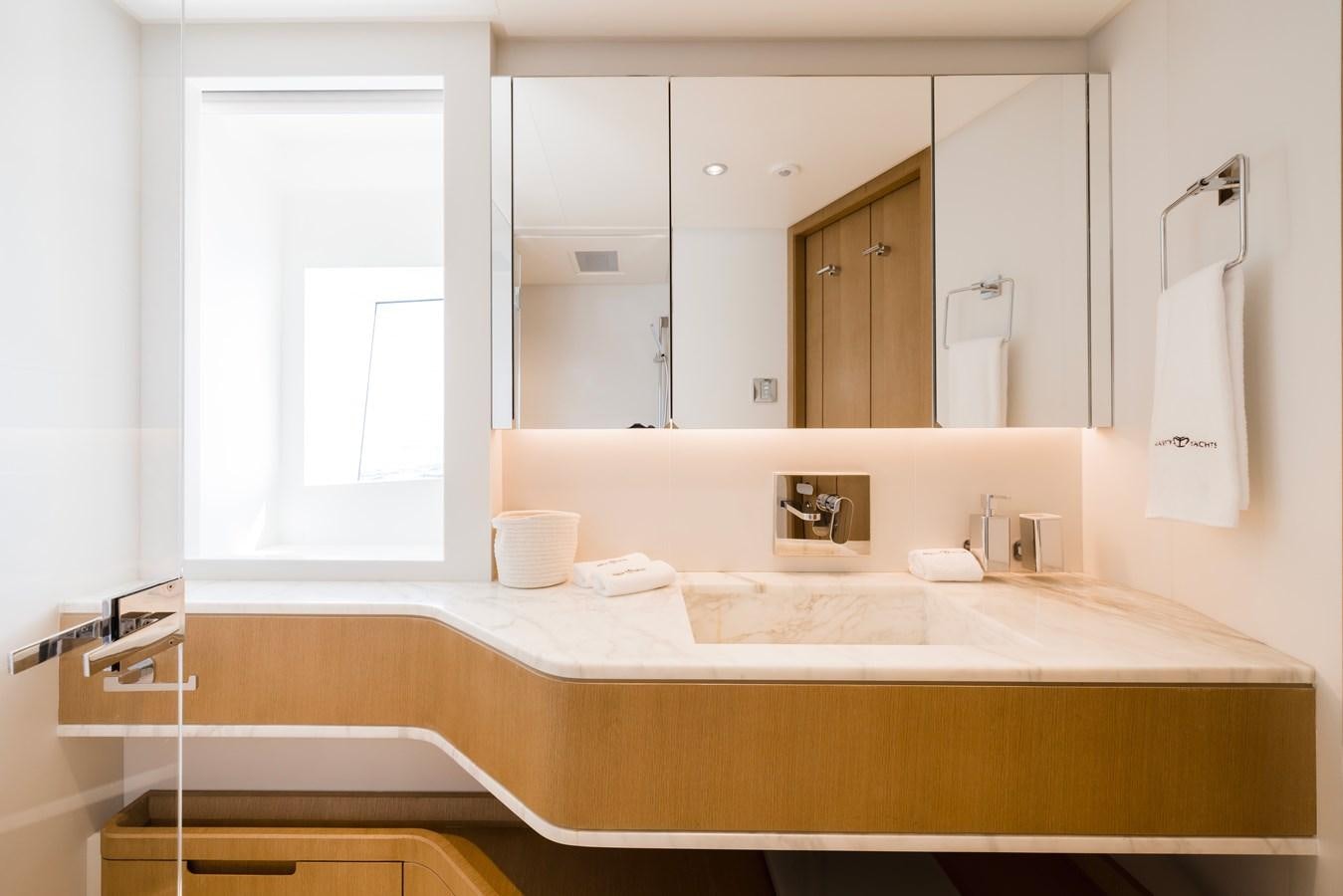 a bathroom with a large mirror aboard MAJESTY 111 Yacht for Sale