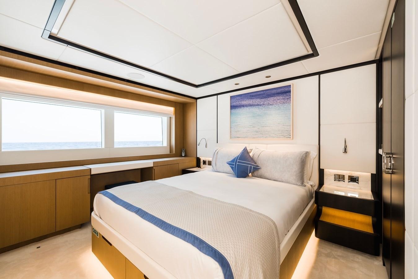 a room with a bed and a window aboard MAJESTY 111 Yacht for Sale