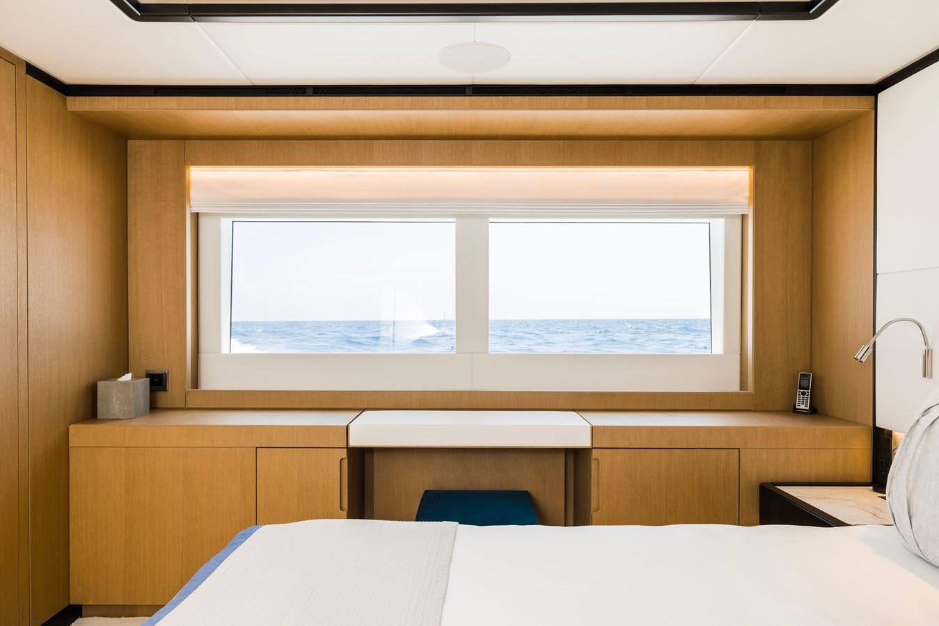 a room with a window and a bed aboard MAJESTY 111 Yacht for Sale
