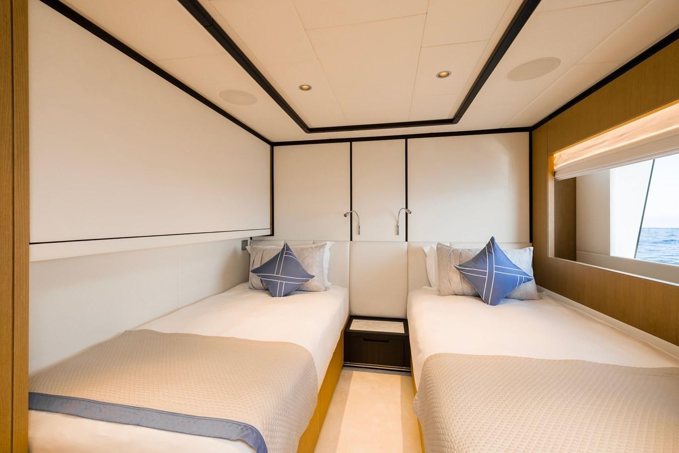 a room with two beds aboard MAJESTY 111 Yacht for Sale