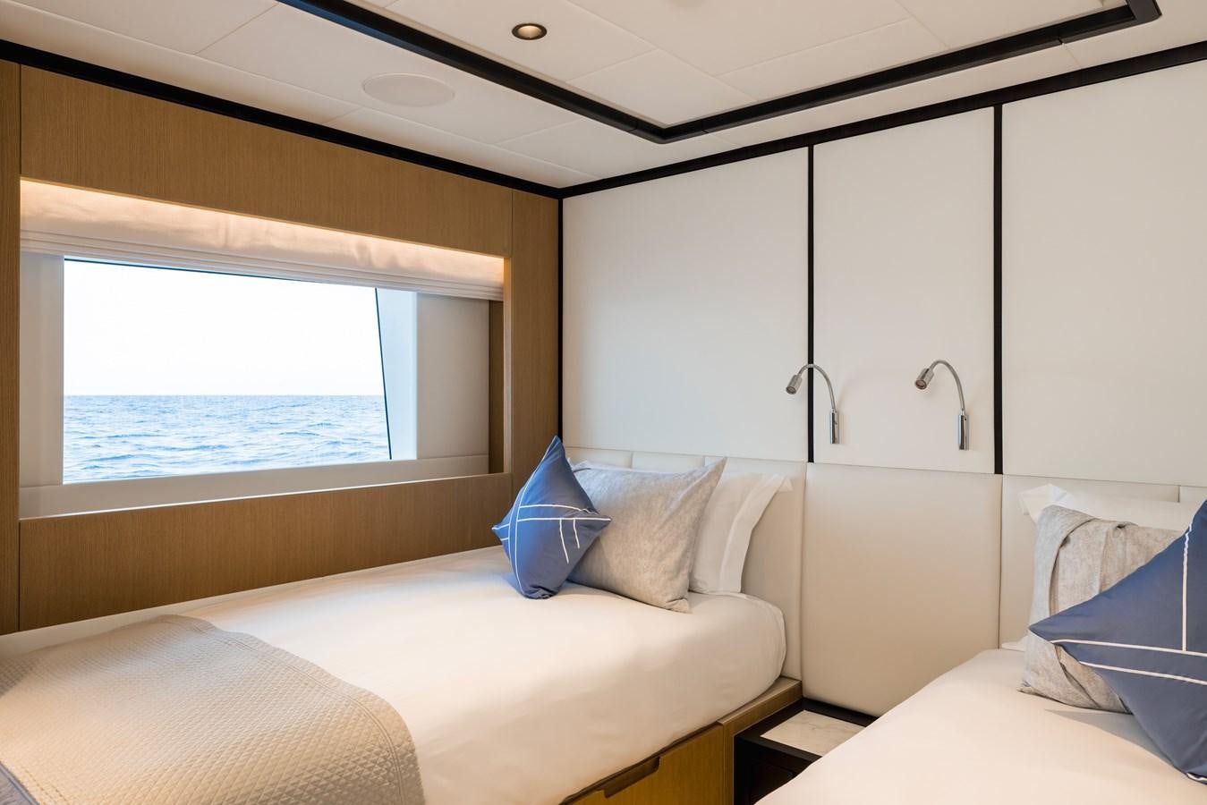 a room with a bed and a window aboard MAJESTY 111 Yacht for Sale