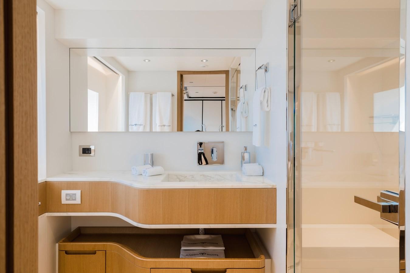 a bathroom with a sink and cabinets aboard MAJESTY 111 Yacht for Sale
