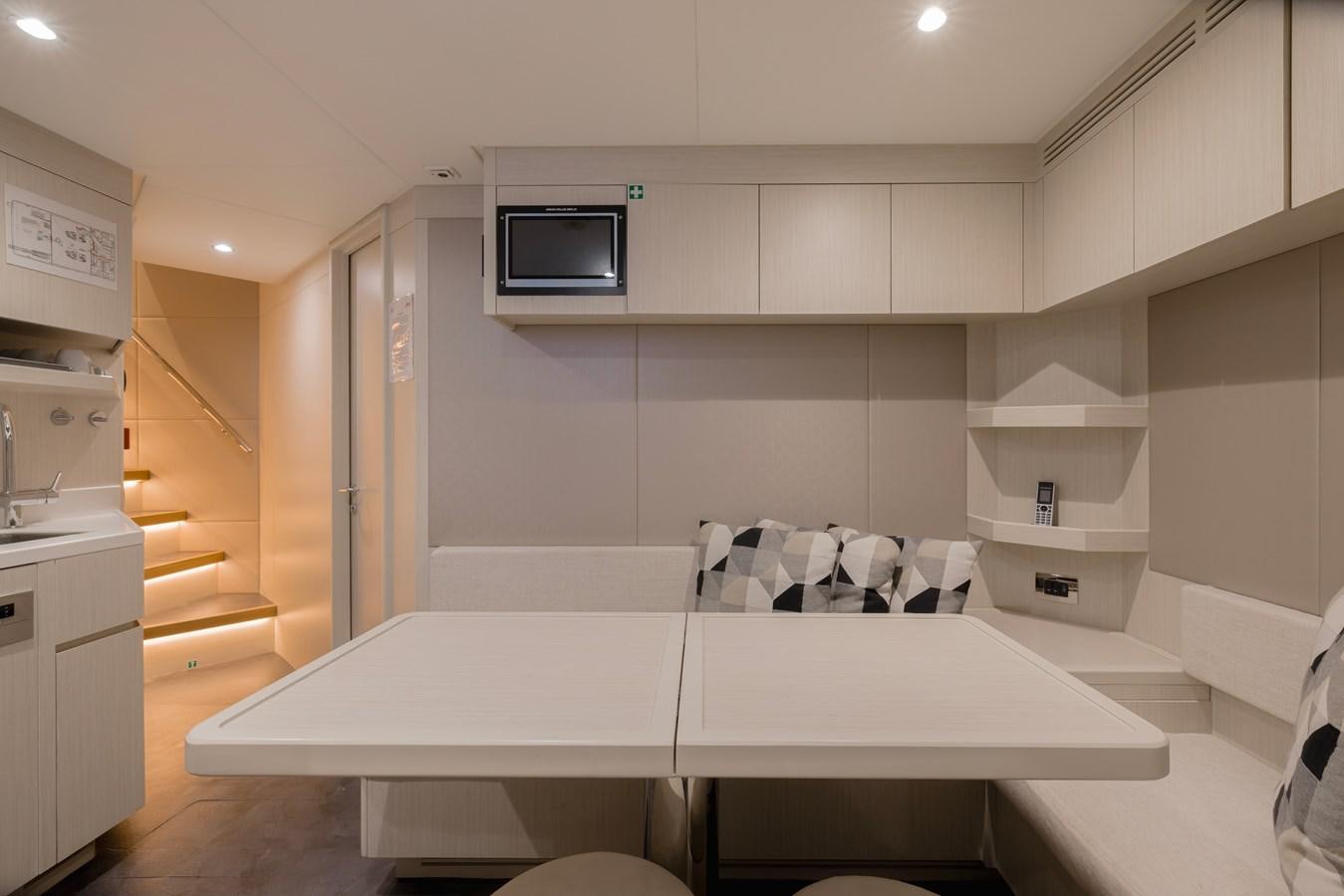a kitchen with white cabinets aboard MAJESTY 111 Yacht for Sale