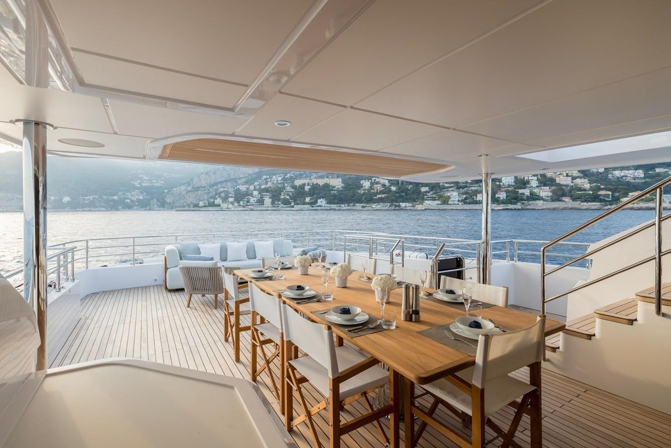 a room with a table and chairs aboard MAJESTY 111 Yacht for Sale
