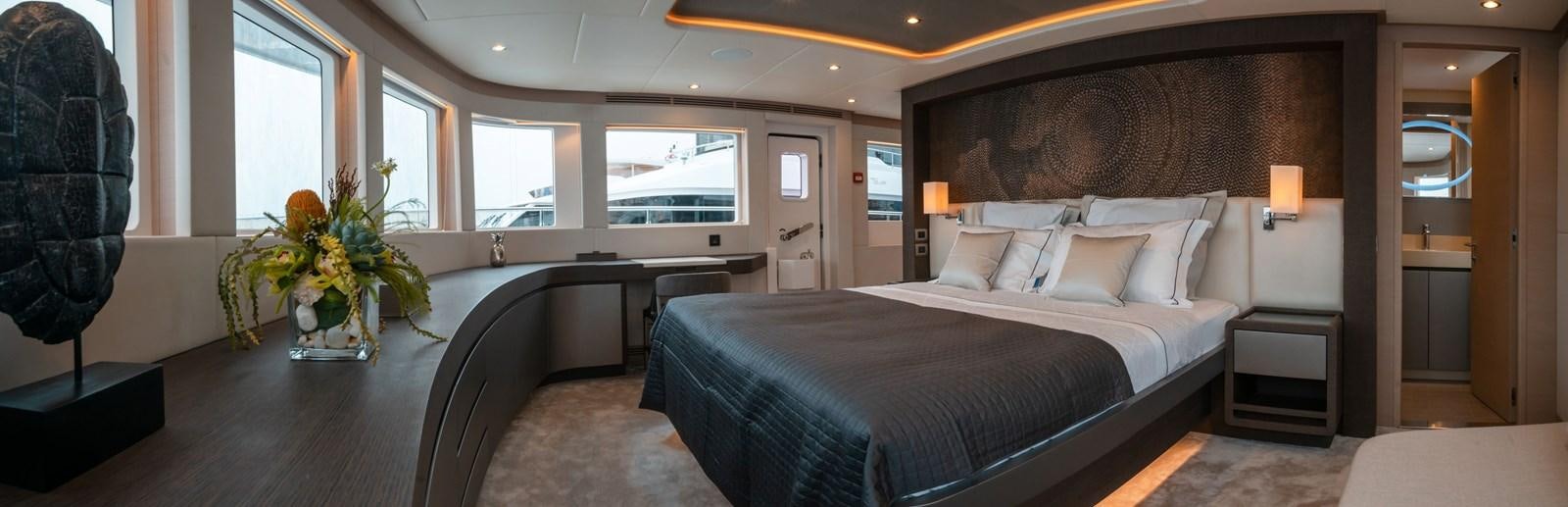 a large bedroom with a bed aboard NOMAD 95 SUV Yacht for Sale