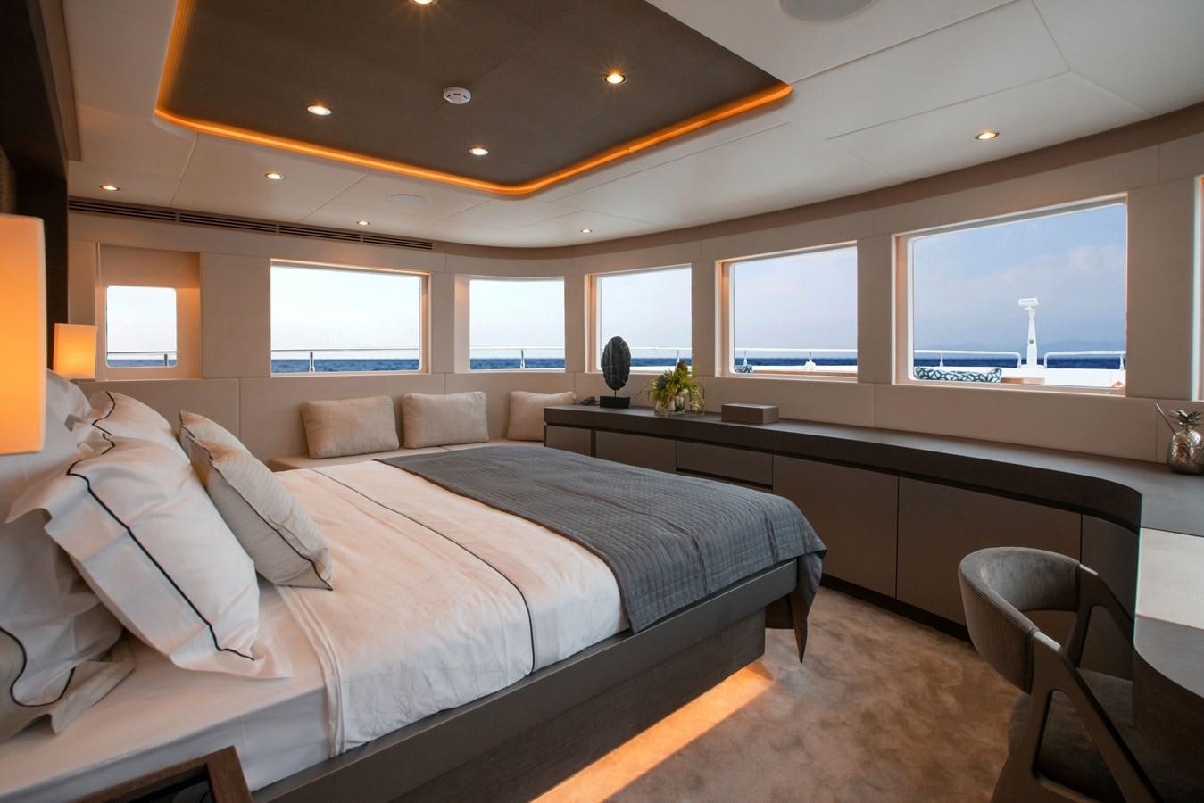 a room with a bed and a desk aboard NOMAD 95 SUV Yacht for Sale