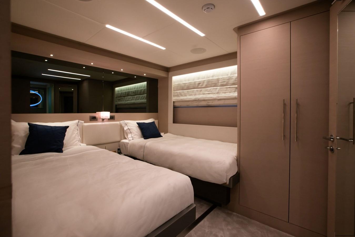 a room with a bed and a closet aboard NOMAD 95 SUV Yacht for Sale