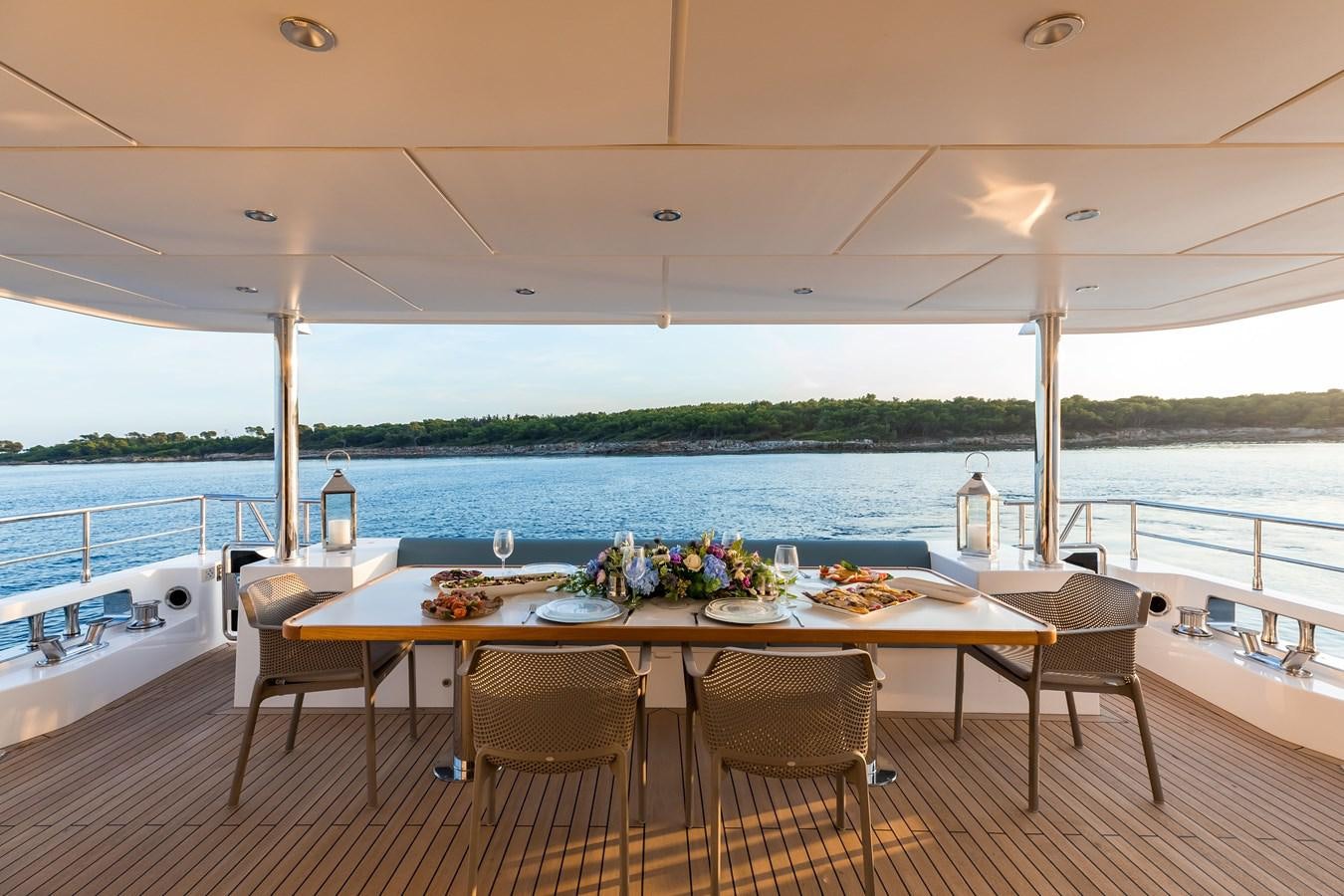 a table set for a meal on a boat aboard NOMAD 95 SUV Yacht for Sale
