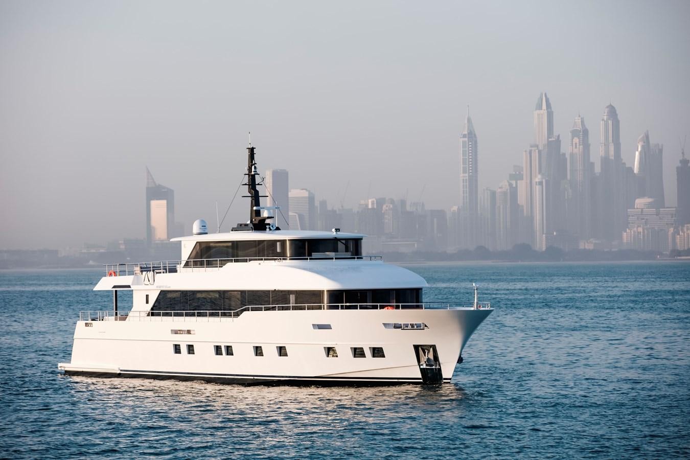 a white boat in the water aboard NOMAD 95 SUV Yacht for Sale