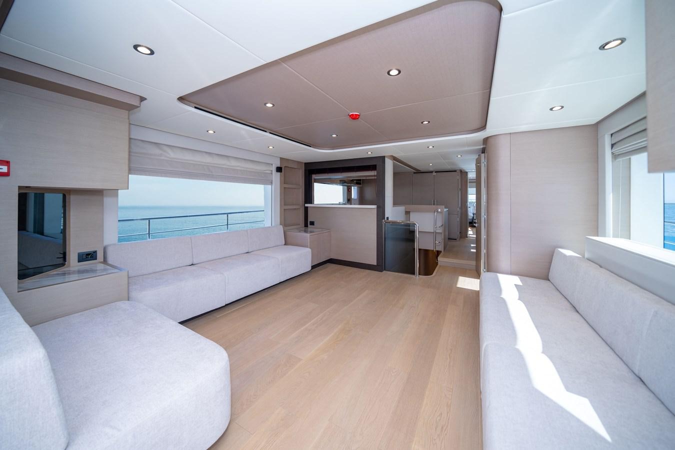 a living room with a large window aboard #4 NOMAD 75 SUV Yacht for Sale