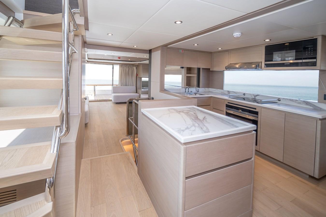 a kitchen with a large island aboard #4 NOMAD 75 SUV Yacht for Sale