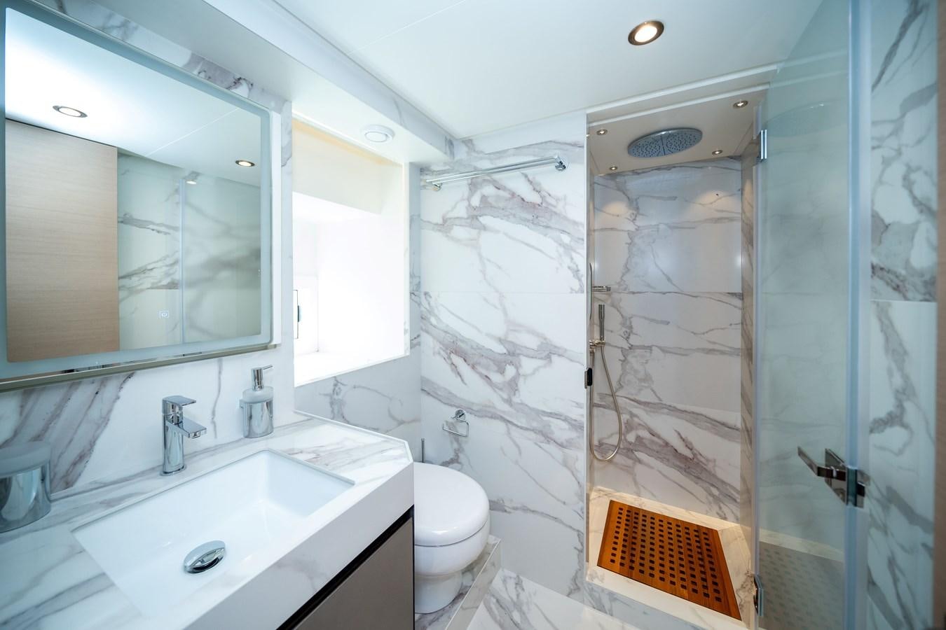 a bathroom with a glass shower aboard #4 NOMAD 75 SUV Yacht for Sale