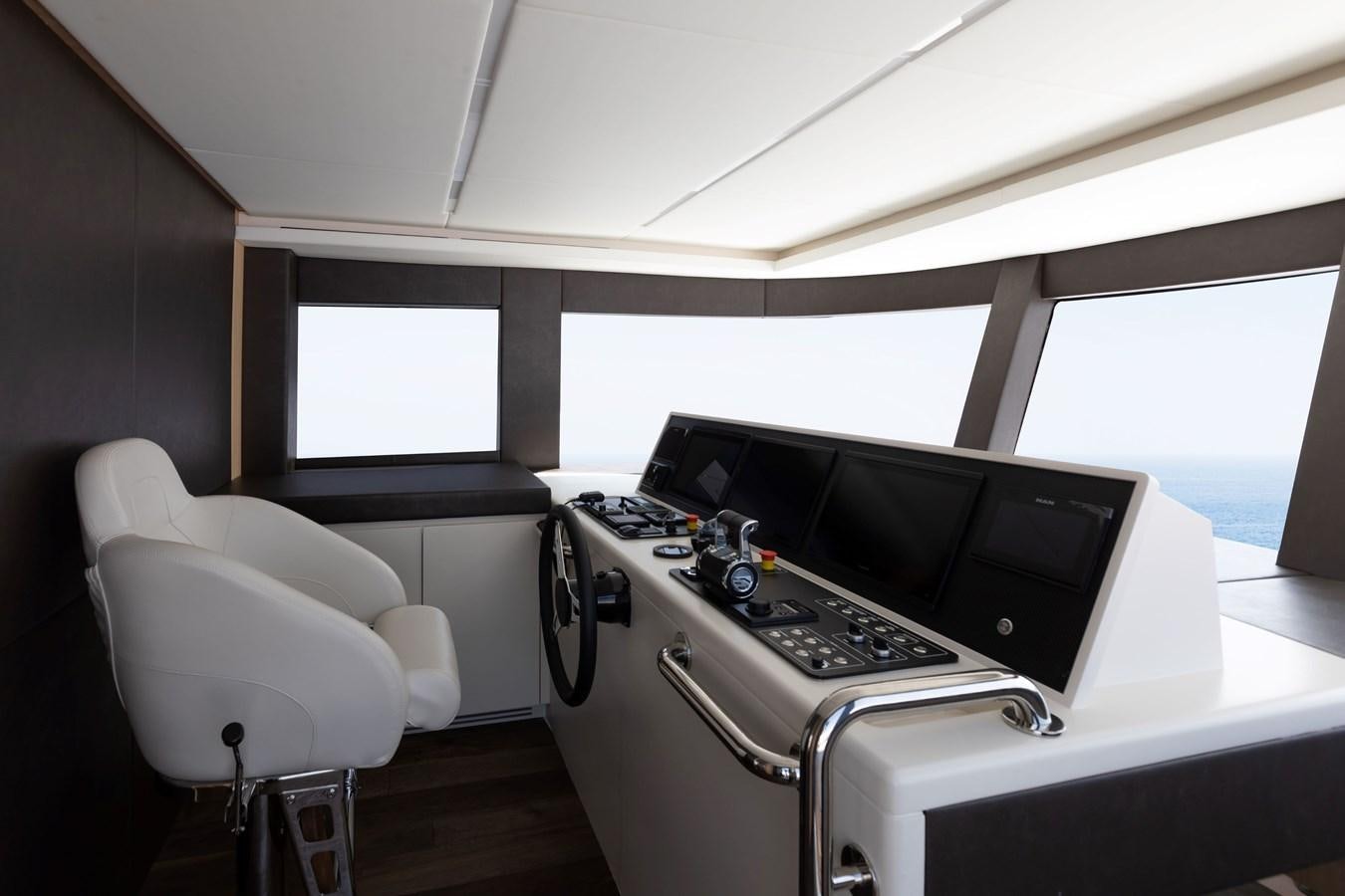 a room with a large window and a desk with a computer aboard NOMAD 70 SUV Yacht for Sale