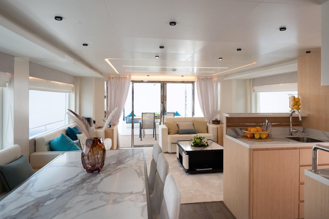 a large kitchen with a large window aboard NOMAD 70 SUV Yacht for Sale