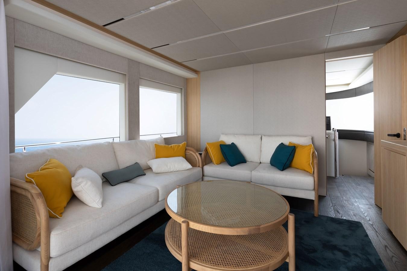 a living room with a couch and a table aboard NOMAD 70 SUV Yacht for Sale