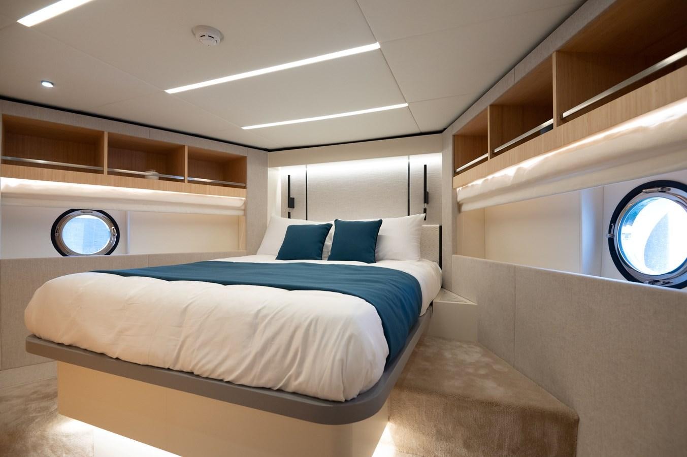 a room with a bed and a window aboard NOMAD 70 SUV Yacht for Sale