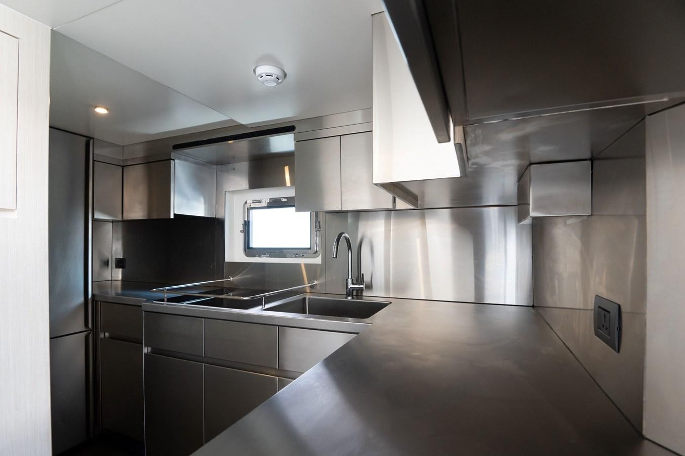 a kitchen with a sink and cabinets aboard NOMAD 70 SUV Yacht for Sale