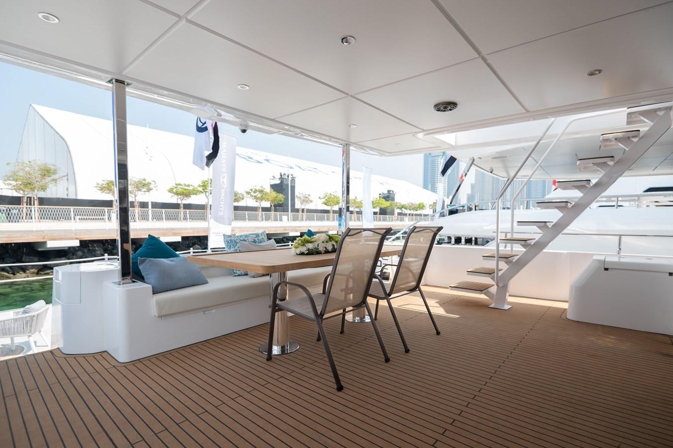 a room with a table and chairs aboard NOMAD 70 SUV Yacht for Sale