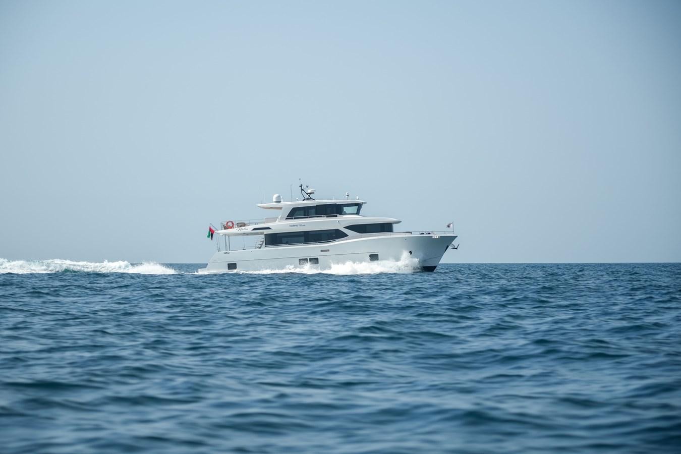 a white yacht in the water aboard NOMAD 70 SUV Yacht for Sale
