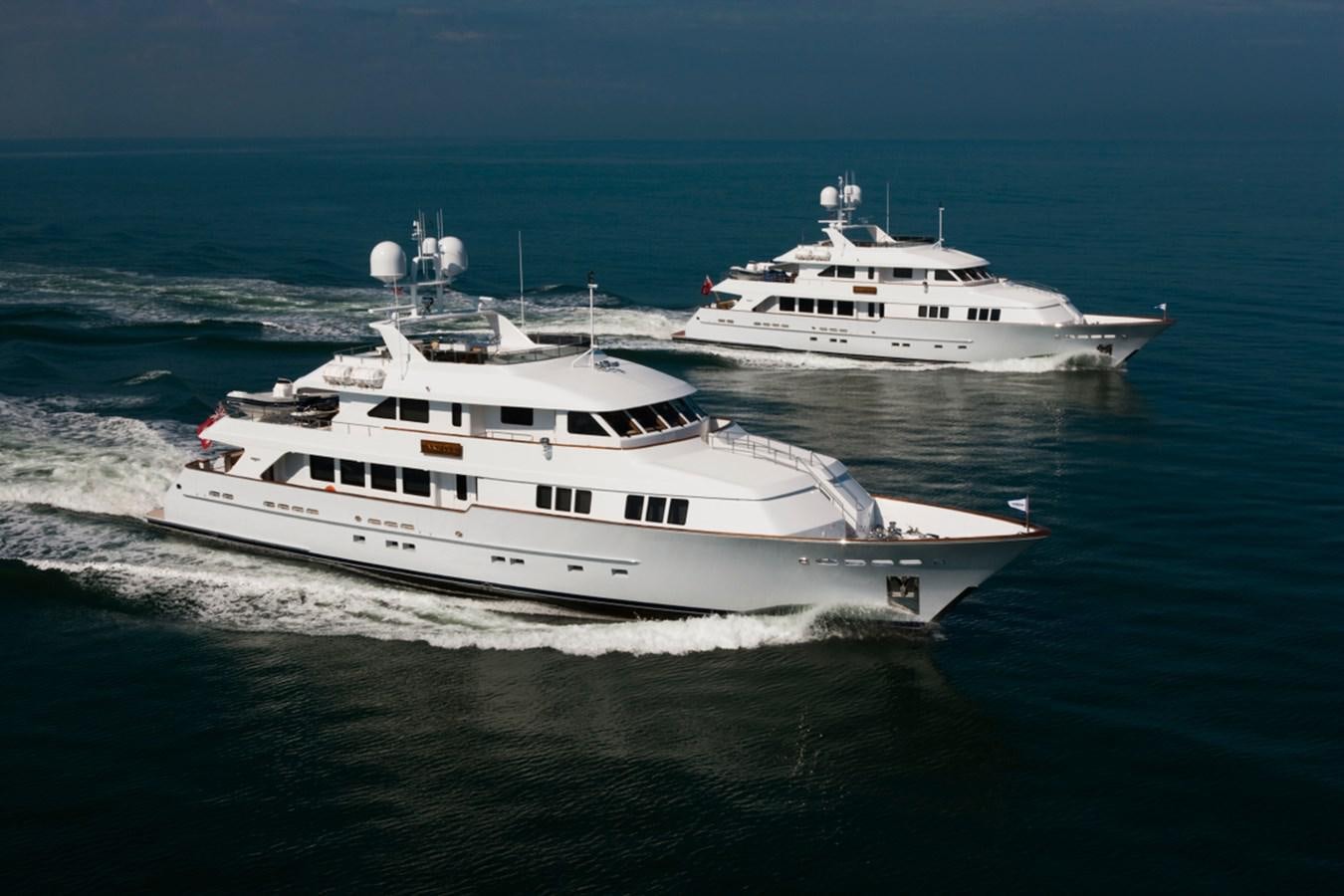 a couple of white yachts on the water aboard ARETI I Yacht for Sale