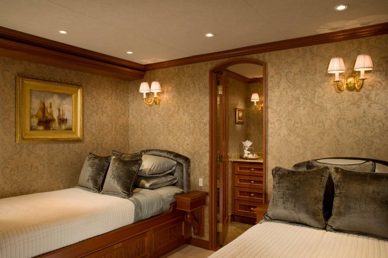 a bedroom with two beds aboard ARETI I Yacht for Sale