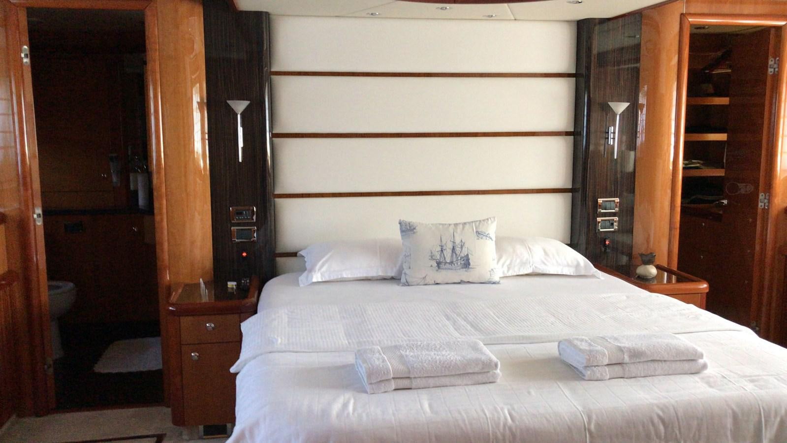 a bed with white sheets aboard MYA Yacht for Sale