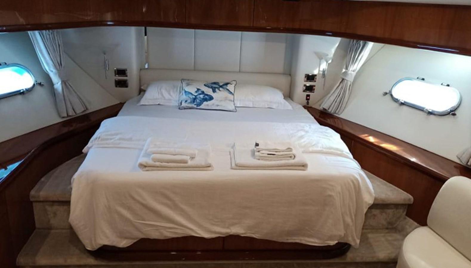 a bed with white sheets aboard MYA Yacht for Sale