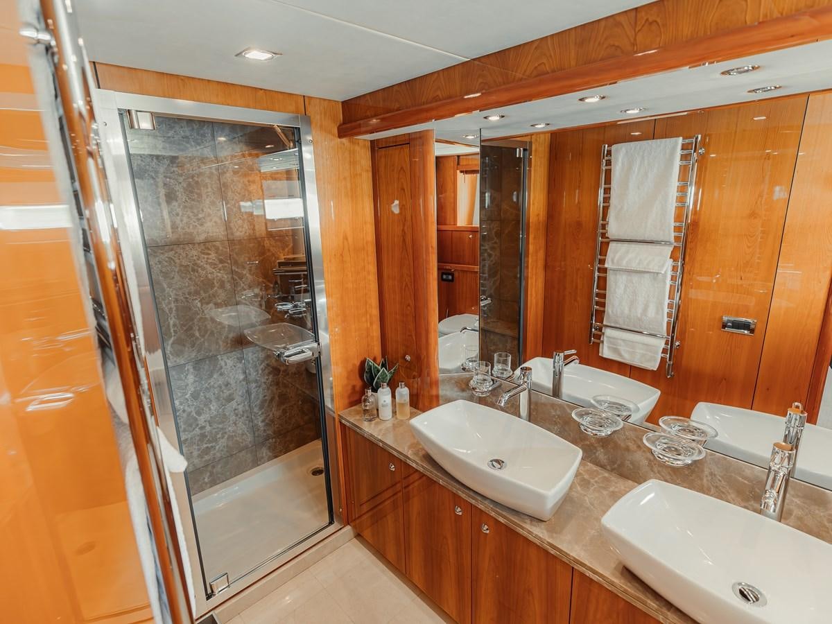 a bathroom with a large mirror aboard AARNA Yacht for Sale