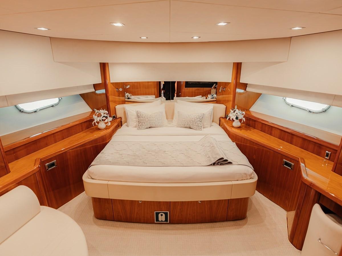 a room with a bed and a window aboard AARNA Yacht for Sale