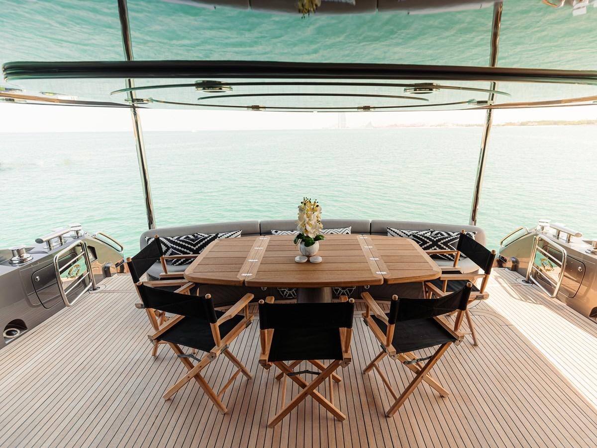 a table and chairs on a deck aboard MATRIX Yacht for Sale