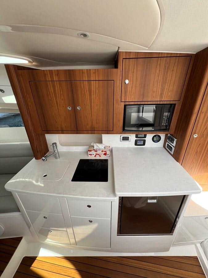 a kitchen with a microwave oven aboard 2023 INTREPID 41 VALOR Yacht for Sale