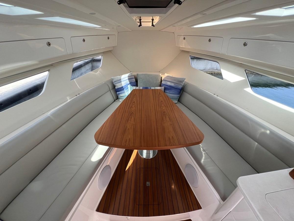 a wooden table in a room aboard 2023 INTREPID 41 VALOR Yacht for Sale