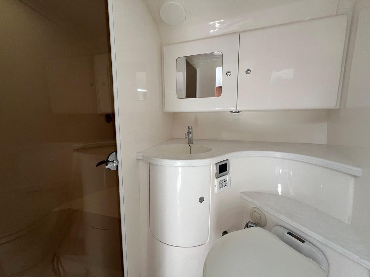 a bathroom with a sink and a toilet aboard 2023 INTREPID 41 VALOR Yacht for Sale