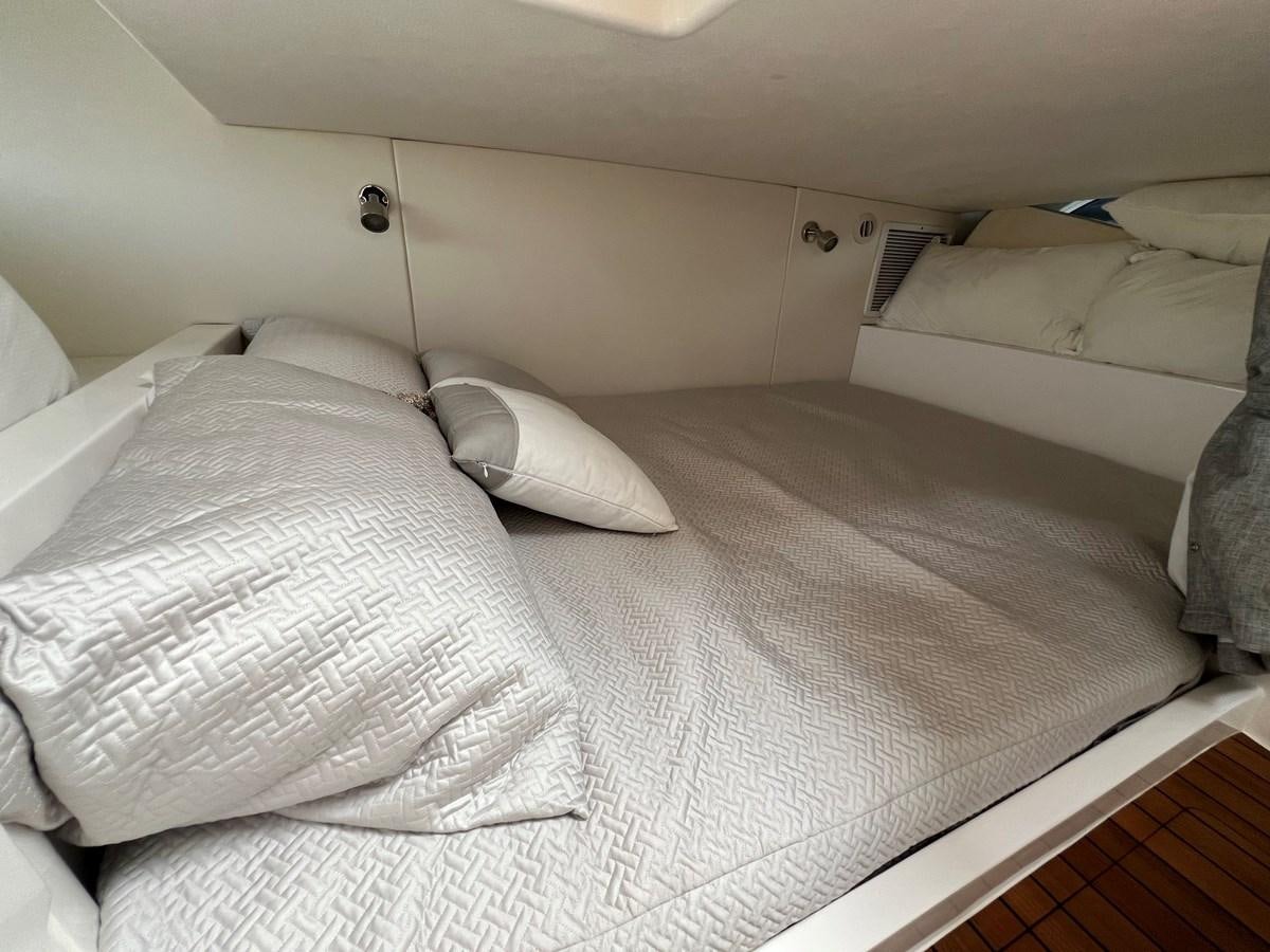 a bed with white sheets aboard 2023 INTREPID 41 VALOR Yacht for Sale
