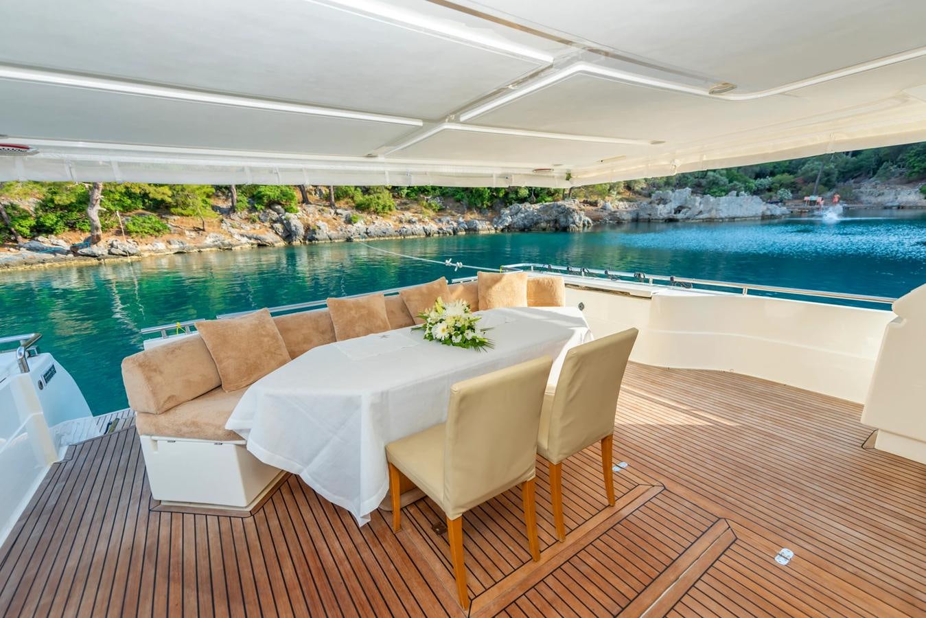 a table and chairs on a deck aboard LOTUS Yacht for Sale