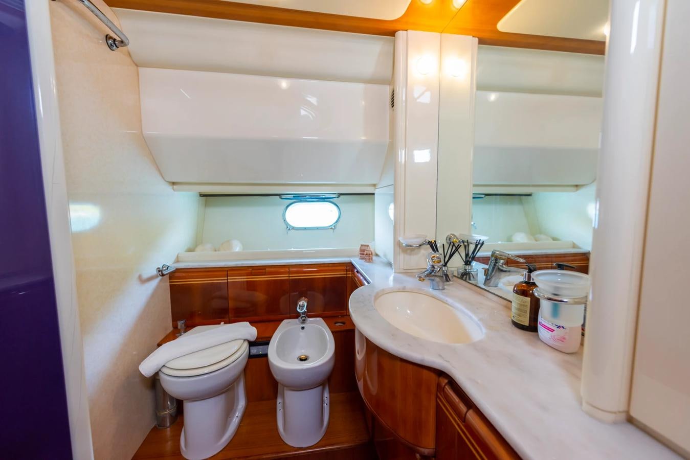 a bathroom with a toilet and sink aboard LOTUS Yacht for Sale