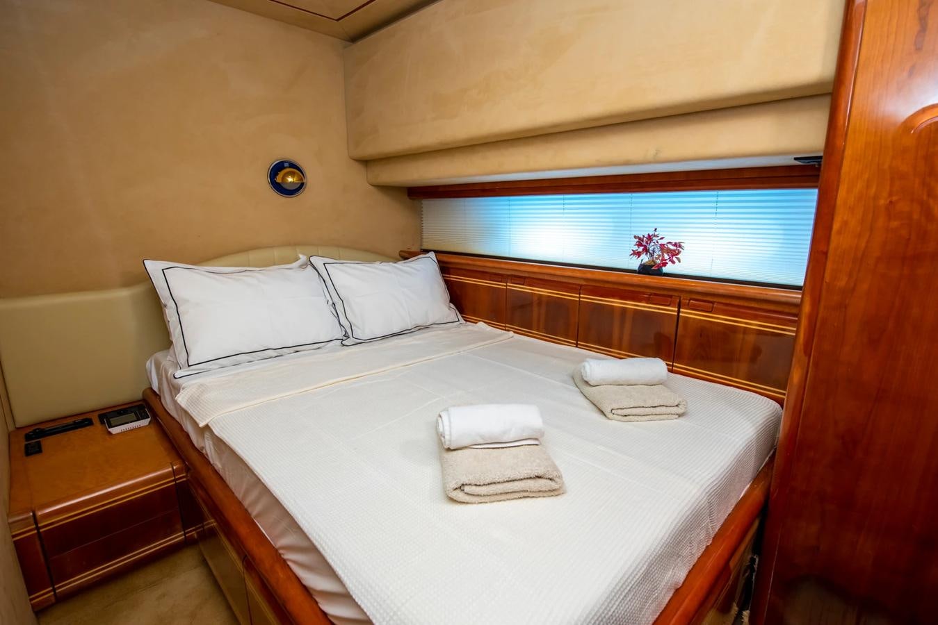 a bed with white sheets aboard LOTUS Yacht for Sale