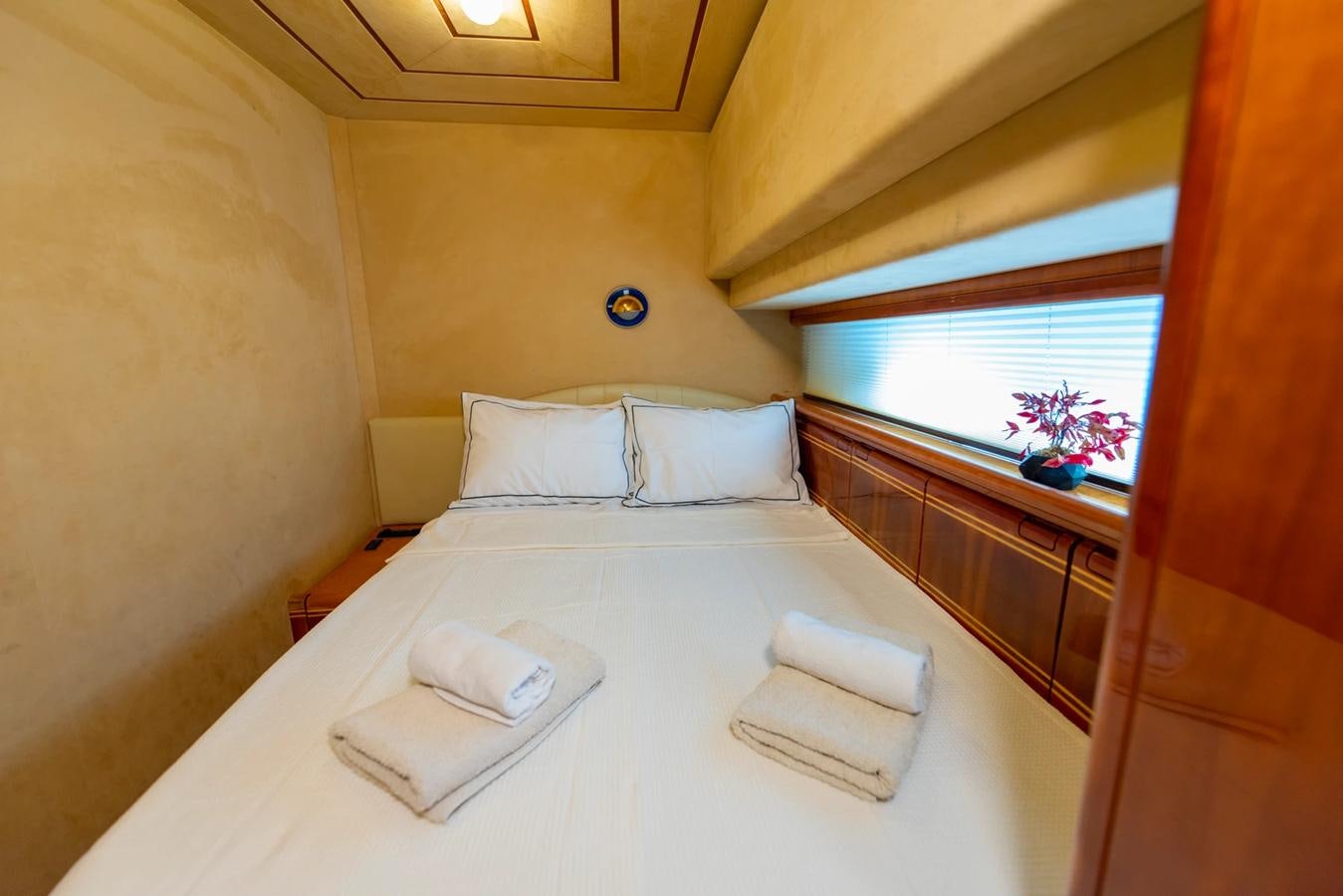 a bed with white sheets aboard LOTUS Yacht for Sale