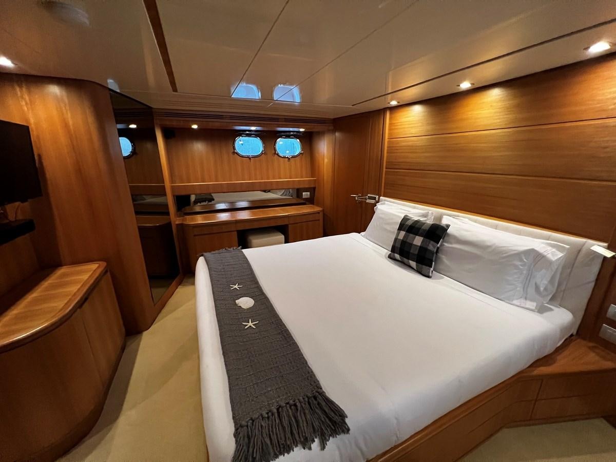 a bed with white sheets aboard KOKO Yacht for Sale