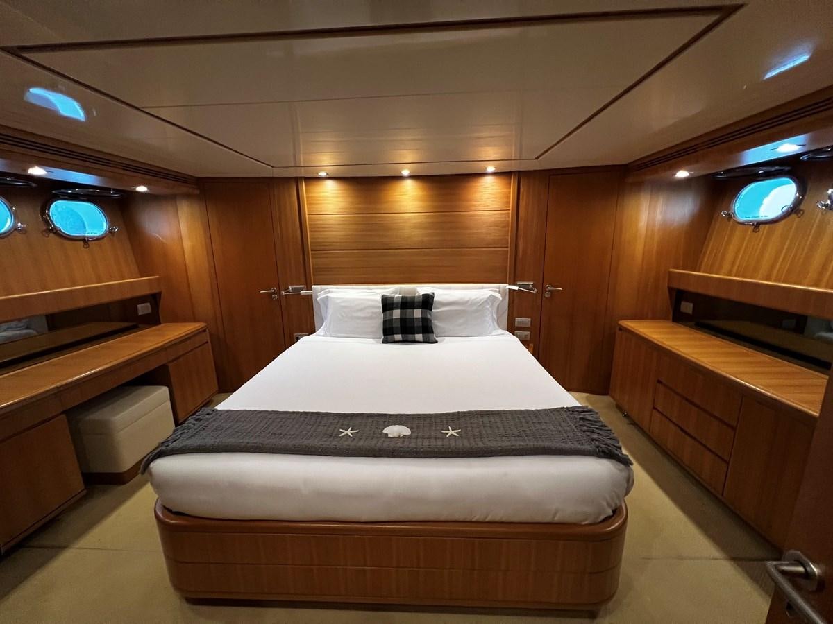 a room with a bed and desk aboard KOKO Yacht for Sale