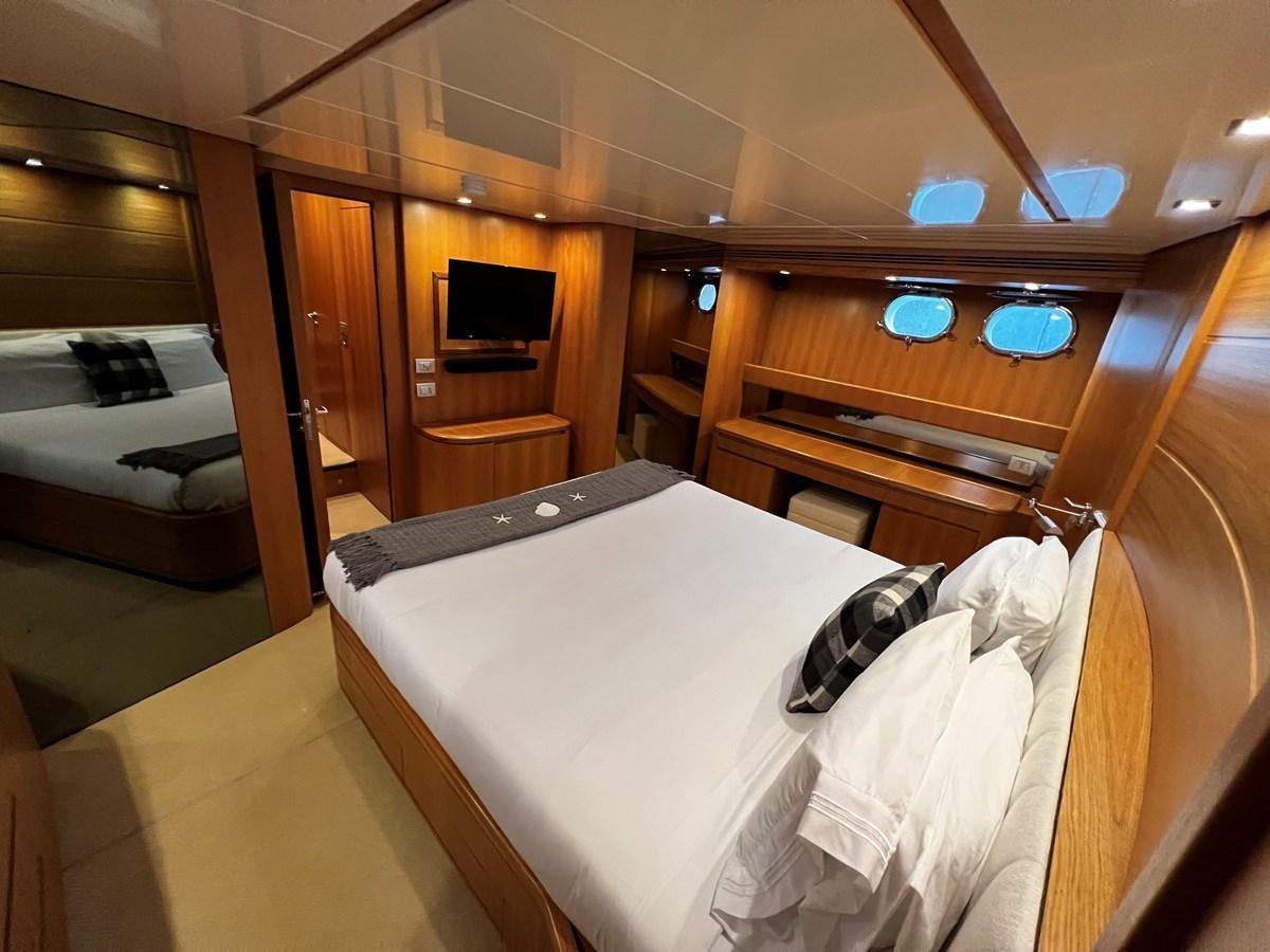 a room with a bed and a television aboard KOKO Yacht for Sale