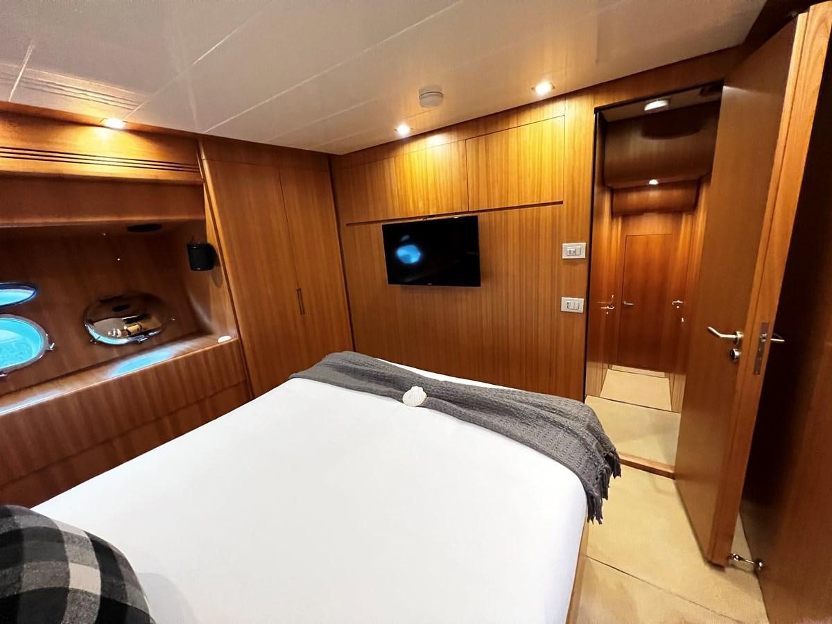 a bedroom with a bed and a television aboard KOKO Yacht for Sale