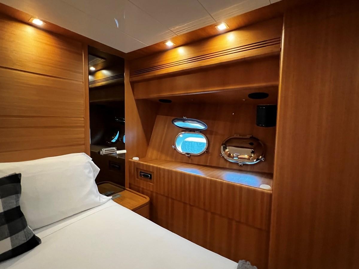 a room with a bed and a mirror aboard KOKO Yacht for Sale