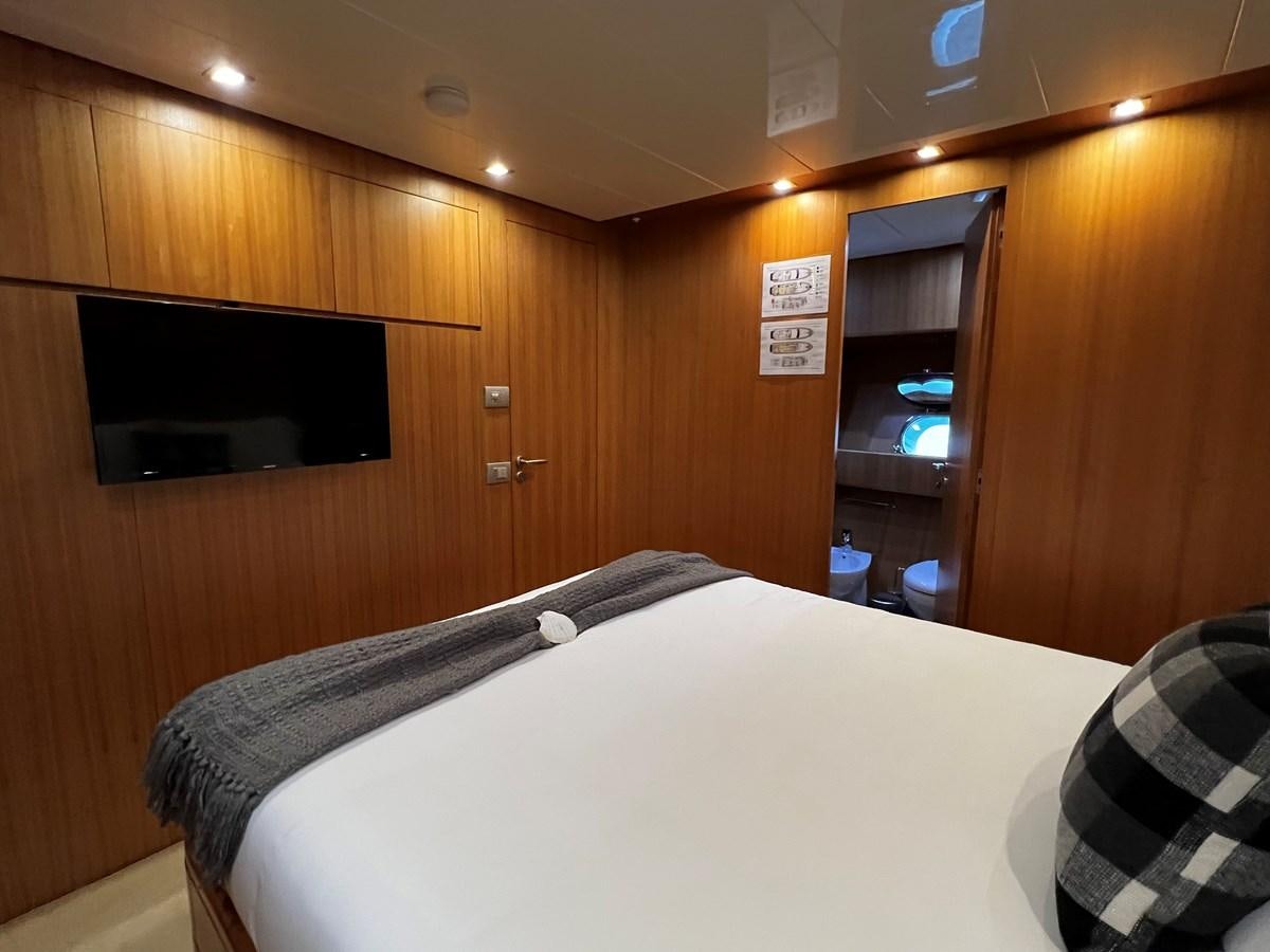a bedroom with a bed and a television aboard KOKO Yacht for Sale