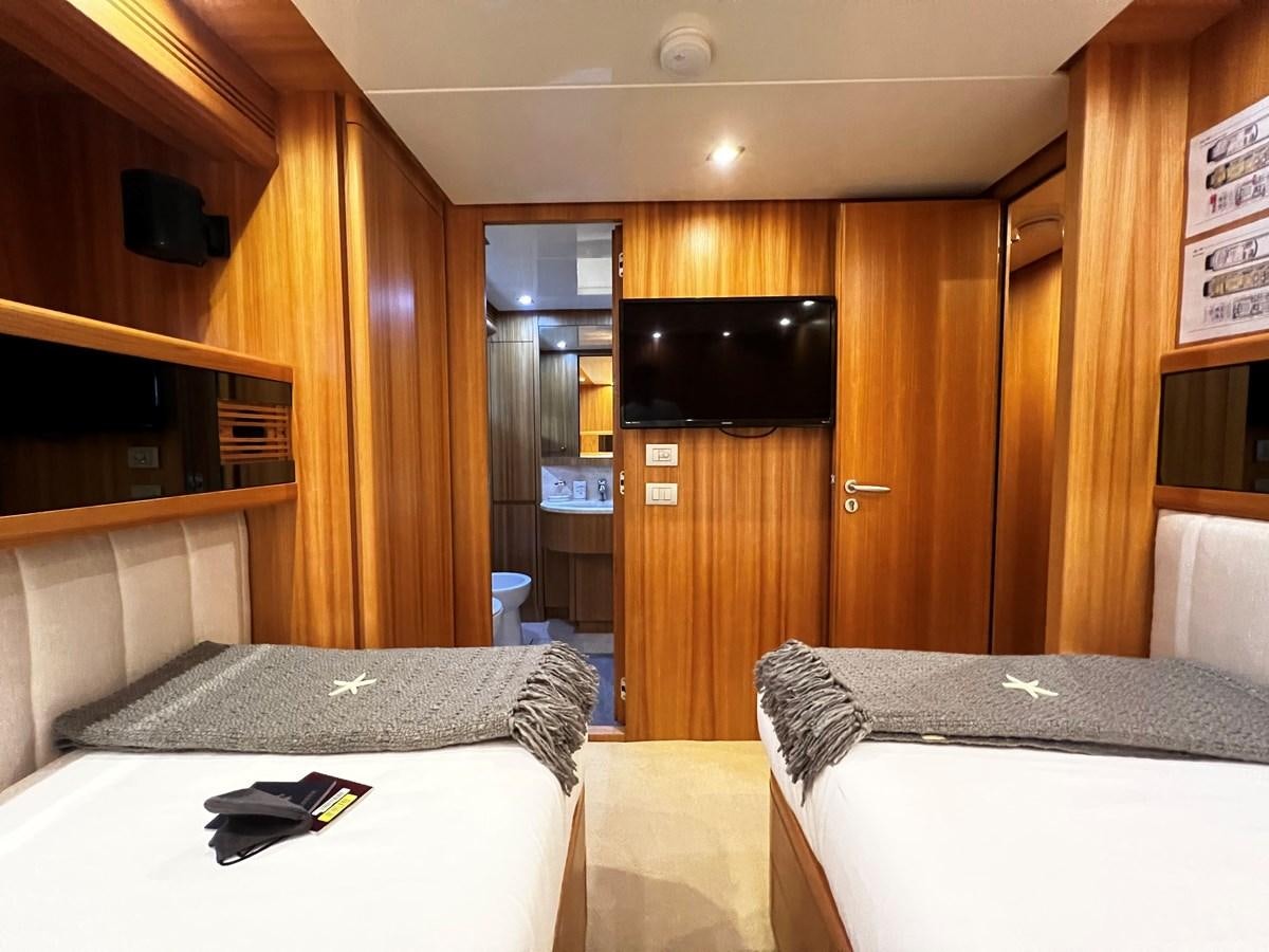 a hotel room with a bed and a television aboard KOKO Yacht for Sale