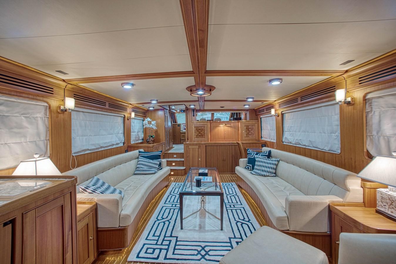 a living room with a couch and a table aboard RODE RUNNER II Yacht for Sale