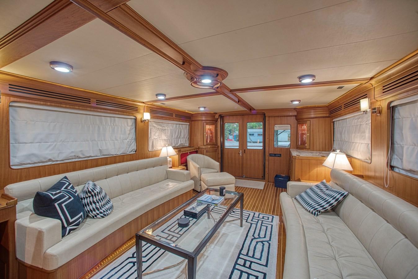 a living room with a couch and a table aboard RODE RUNNER II Yacht for Sale