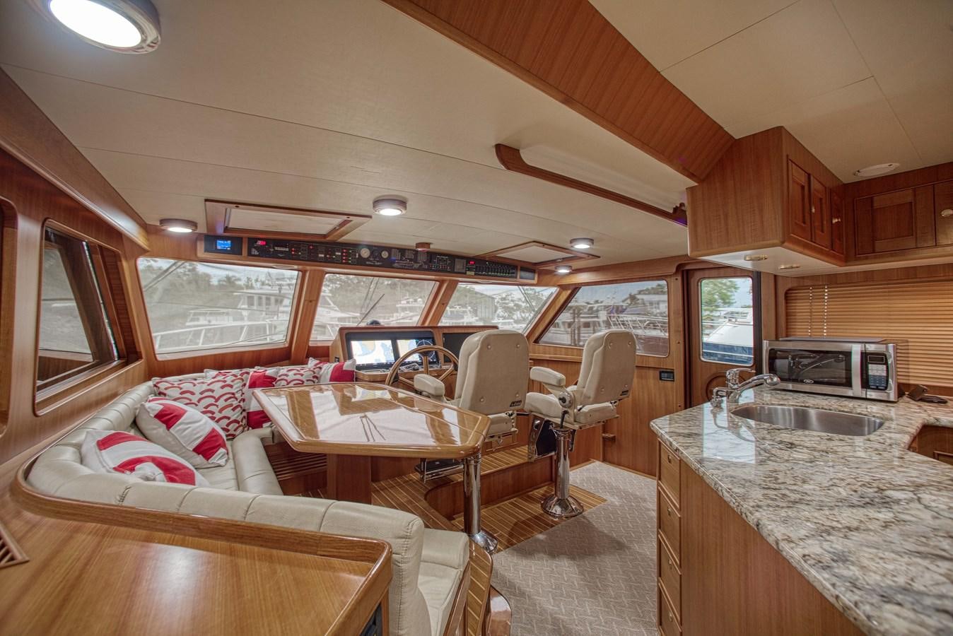 a kitchen and dining area aboard RODE RUNNER II Yacht for Sale