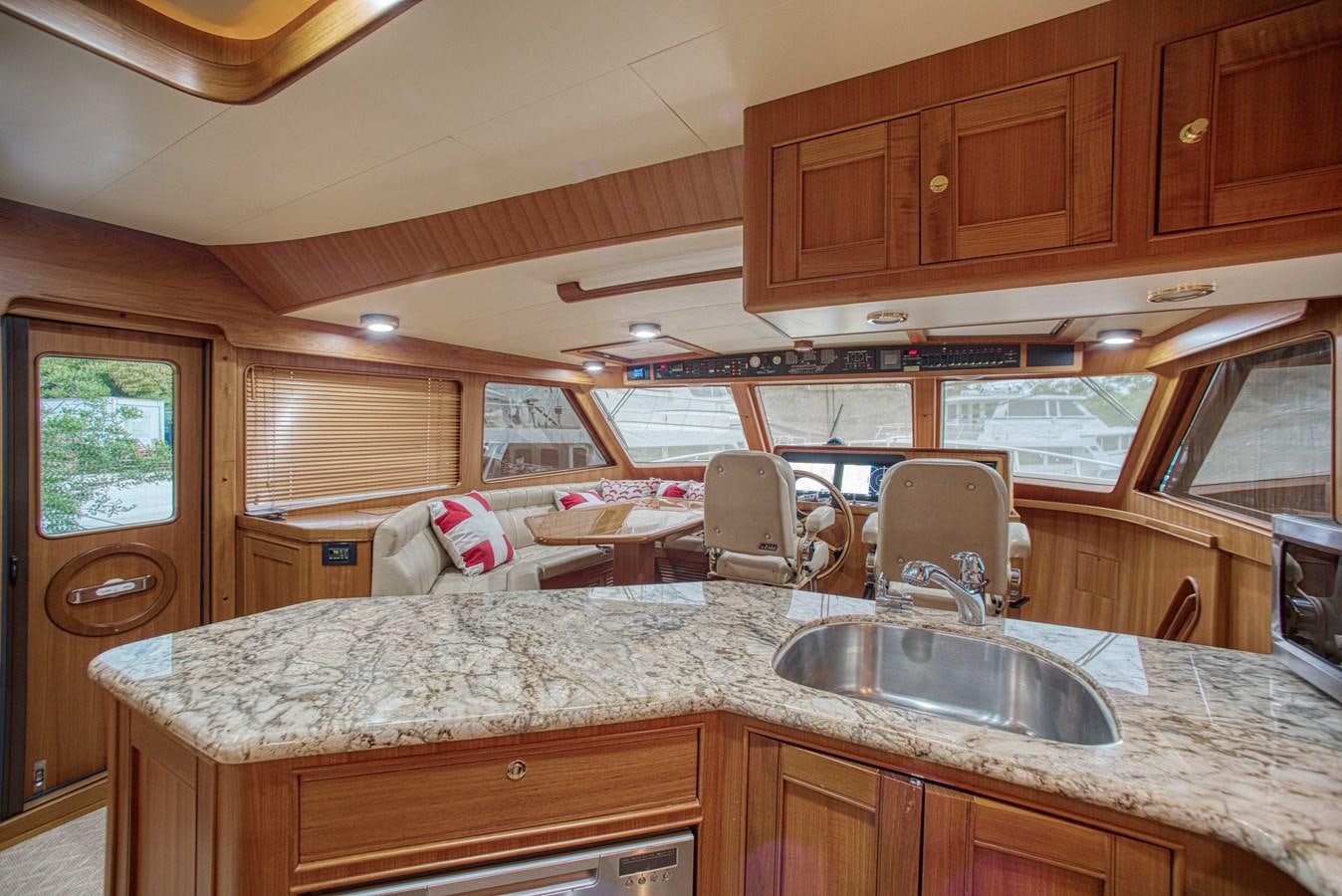a kitchen with wooden cabinets aboard RODE RUNNER II Yacht for Sale