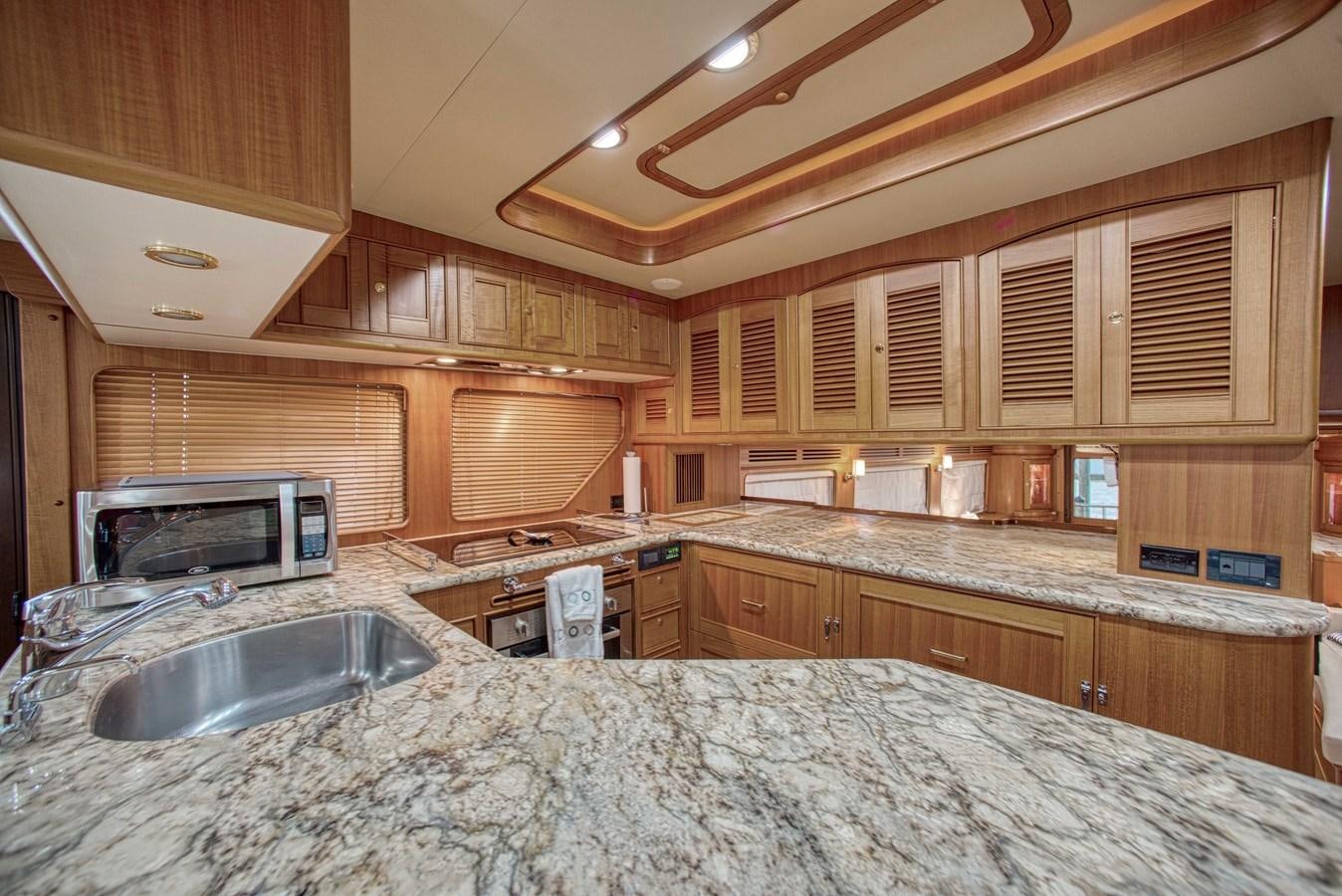 a kitchen with wooden cabinets aboard RODE RUNNER II Yacht for Sale